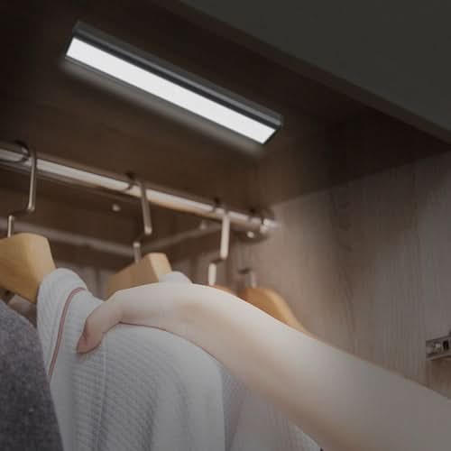 Rechargeable motion sensor LED light bar mounted under cabinet, illuminating workspace