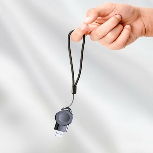 Hand holding Apple iWatch USB Charger with black cord and lanyard attachment