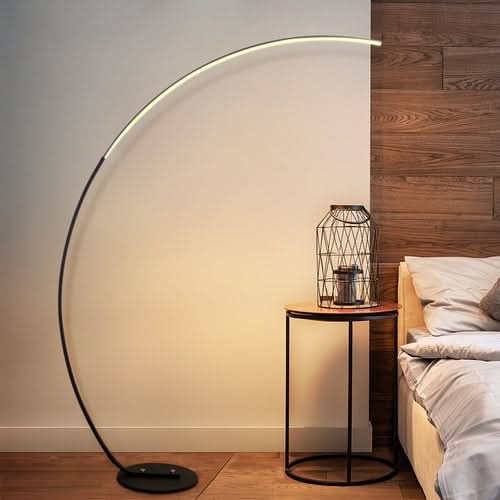 RGBW Modern Curve Floor Lamp with glowing arc shade next to bedroom nightstand