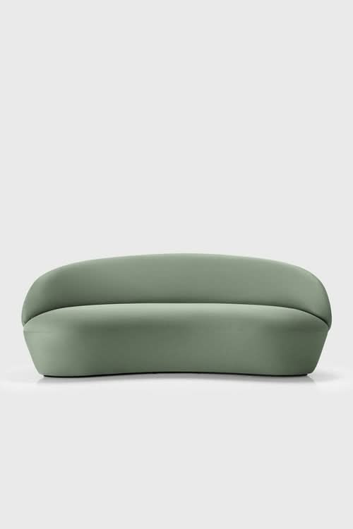 Naïve Sofa in sage green with curved cushioned back and rounded base