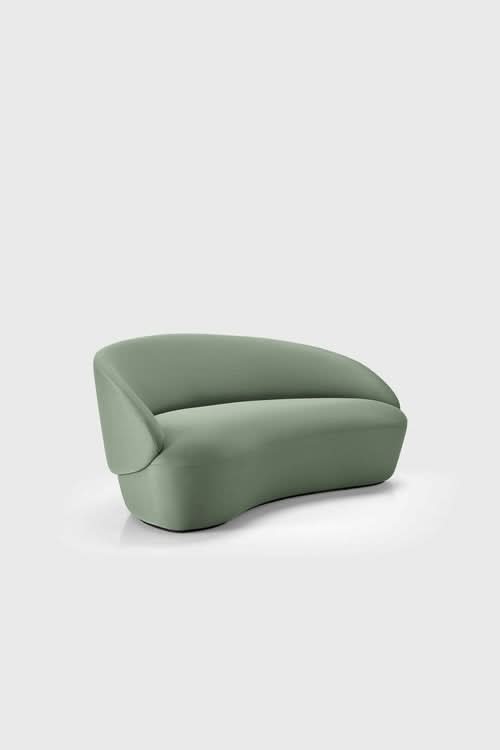 Naïve Sofa in sage green with curved, rounded form and cushioned seating