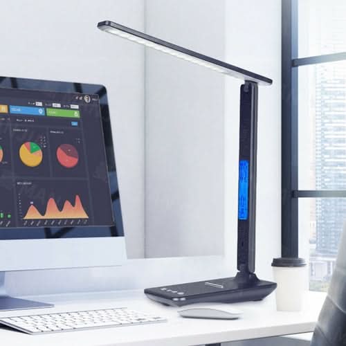 Black desk lamp with phone charger, clock display, and thermostat on white desk