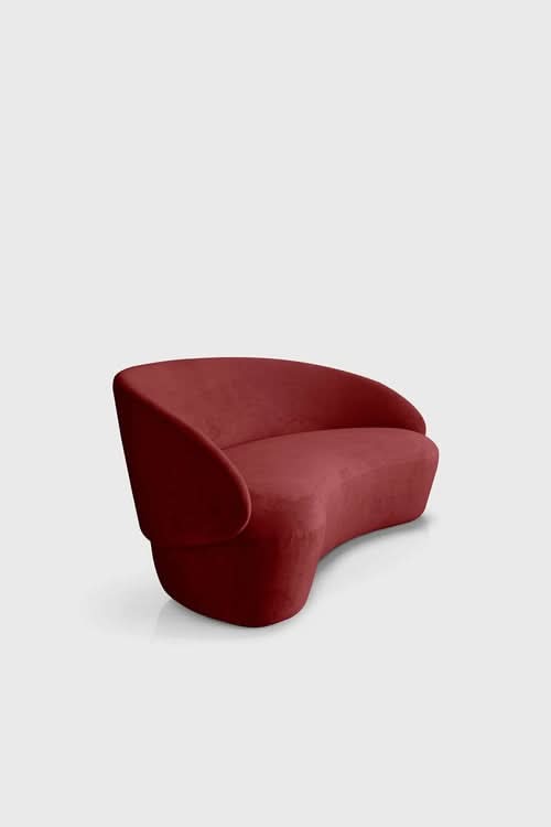Naïve Sofa in deep red upholstery with curved, sculptural form