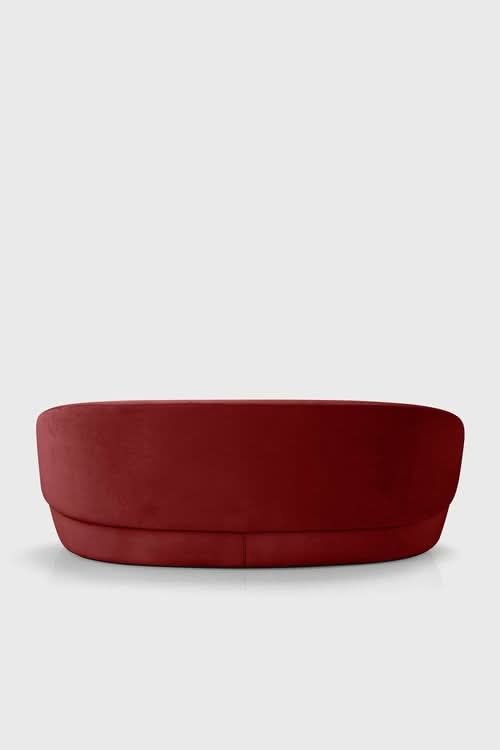 Naïve Sofa in deep red, curved design, side view