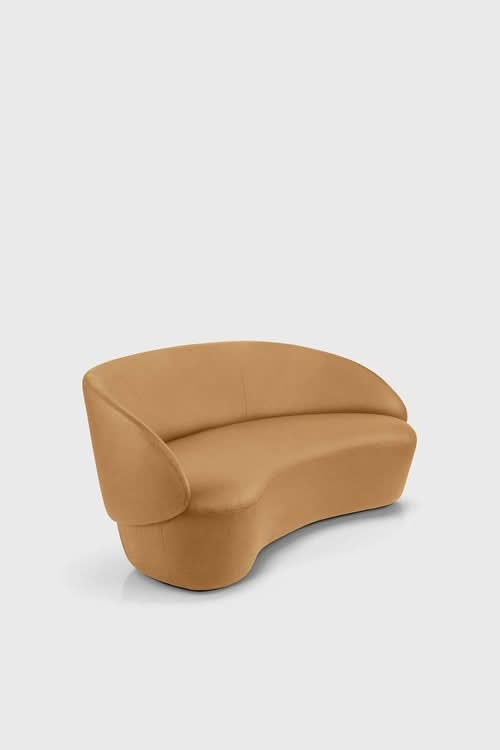 Naïve Sofa in tan upholstery with curved armrests and rounded base