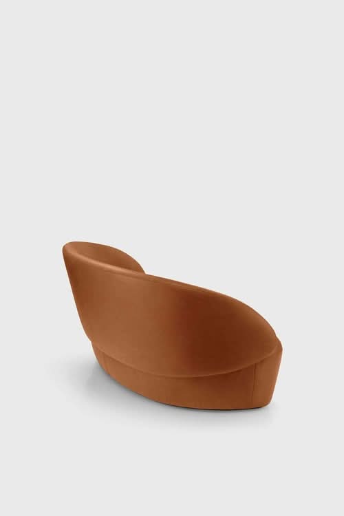 Naïve Sofa in cognac brown, curved modern design with angled back