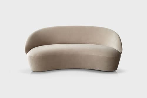 Naïve Sofa, curved beige upholstered seating against white background