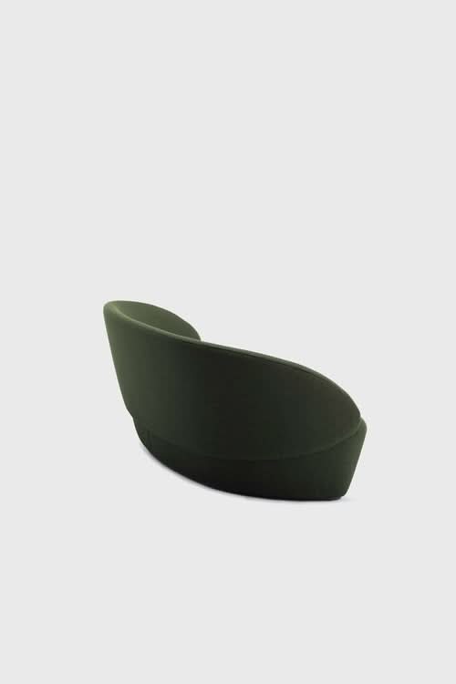 Naïve Sofa in dark green, curved lounge shape against white background