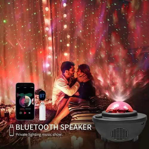 Galaxy projector with Bluetooth speaker projecting colorful lights and stars on wall, with smartphone and remote nearby