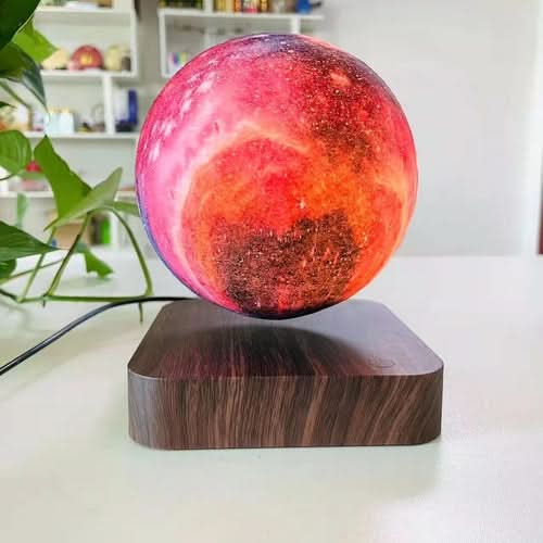 3D Print Moon Lamp with magnetic levitation on dark wood base, glowing pink and orange