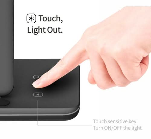 Hand touching illuminated touch-sensitive key on wireless charging station base